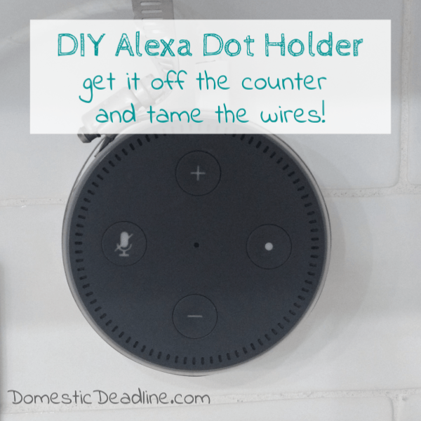 An easy and inexpensive way to hang your Amazon Alexa Dot on the wall near the outlet. This DIY Alexa Dot Holder uses a hose clamp and command hooks. Upcycle Challenge www.domesticdeadline.com