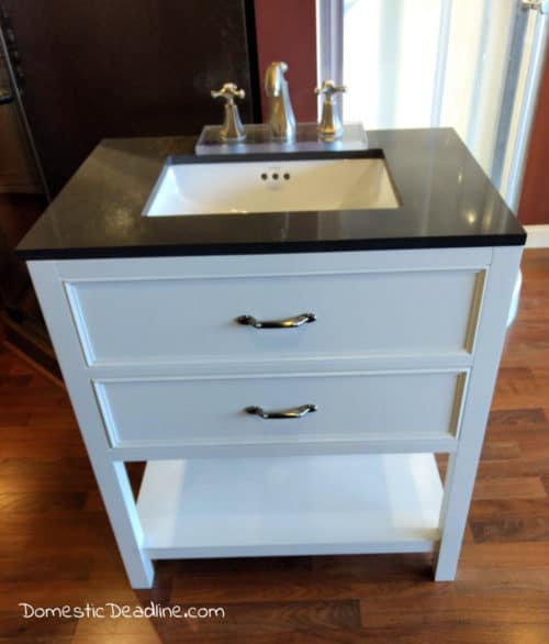 Learn how I found hidden bathroom storage behind the walls and customized our Industrial Farmhouse styled hall bathroom to maximize a small space DomesticDeadline.com