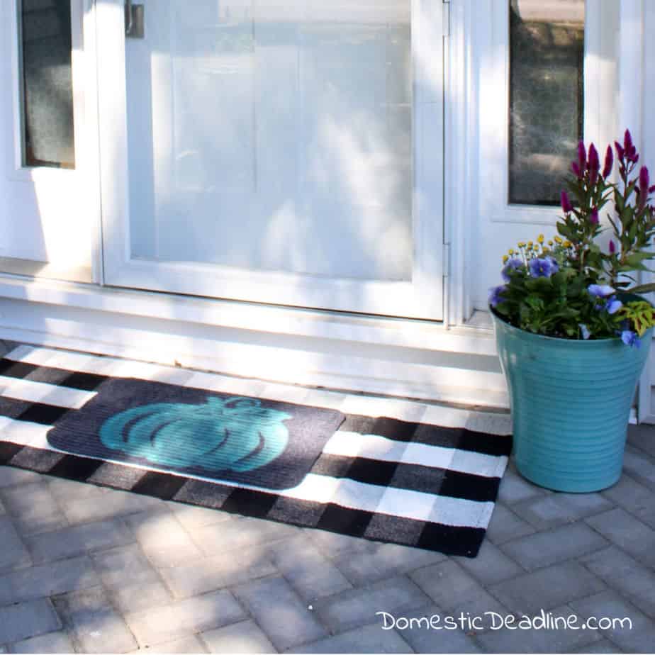 Learn how to make your own pumpkin doormat for only $2 and some basic craft supplies. Customized the fall layered look for your home DomesticDeadline.com