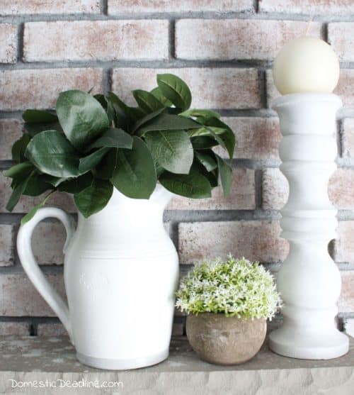 Learn how a few coats of paint can easily transform an old dated ceramic pitcher into a classic farmhouse pitcher full of greenery for mantel decor. DomesticDeadline.com