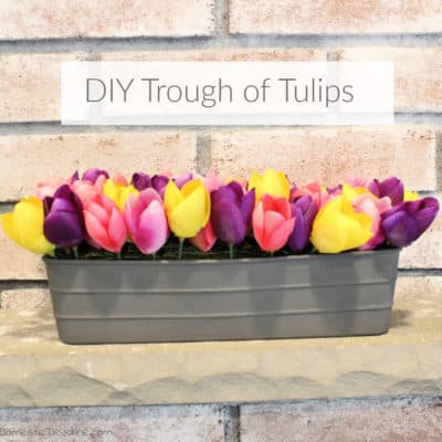 Learn how easy it is to make a DIY metal looking trough. Fill it with tulips or the flowers of your choice for a spring farmhouse decoration. DomesticDeadline.com