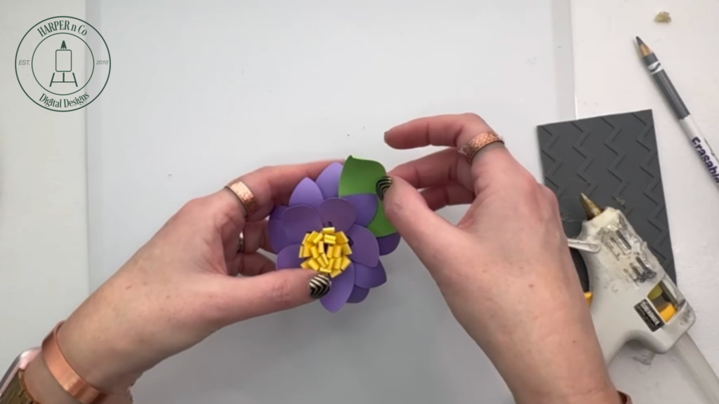 Curling paper leaves before attaching them to a layered 3D paper flower